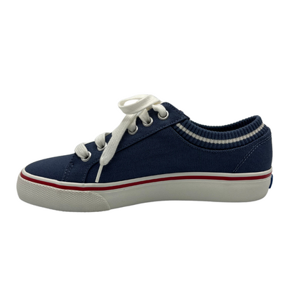 Left facing view of navy canvas shoes with sock opening, white laces and rubber outsole