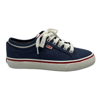 Right facing view of navy canvas shoes with sock opening, white laces and rubber outsole