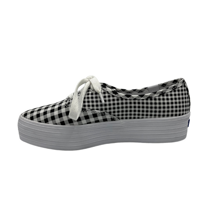 Left facing view of platform, pointed toe sneaker with white laces and black and white gingham design