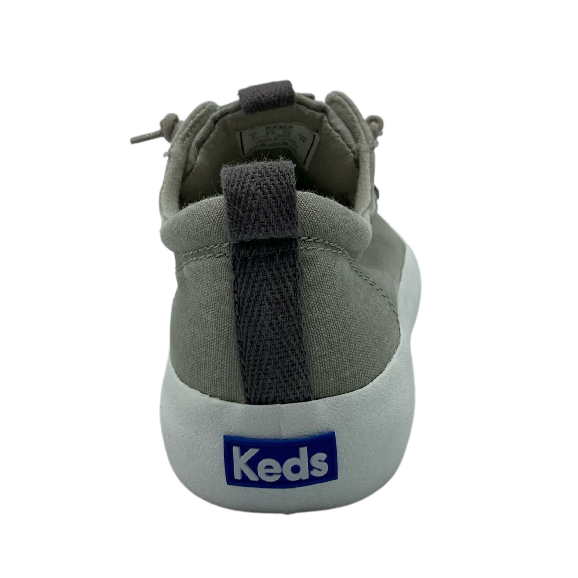 Heel view of shoe with white rubber sole and blue and white Keds logo. Dark grey pull on tab from the top of the sole to top of the ankle