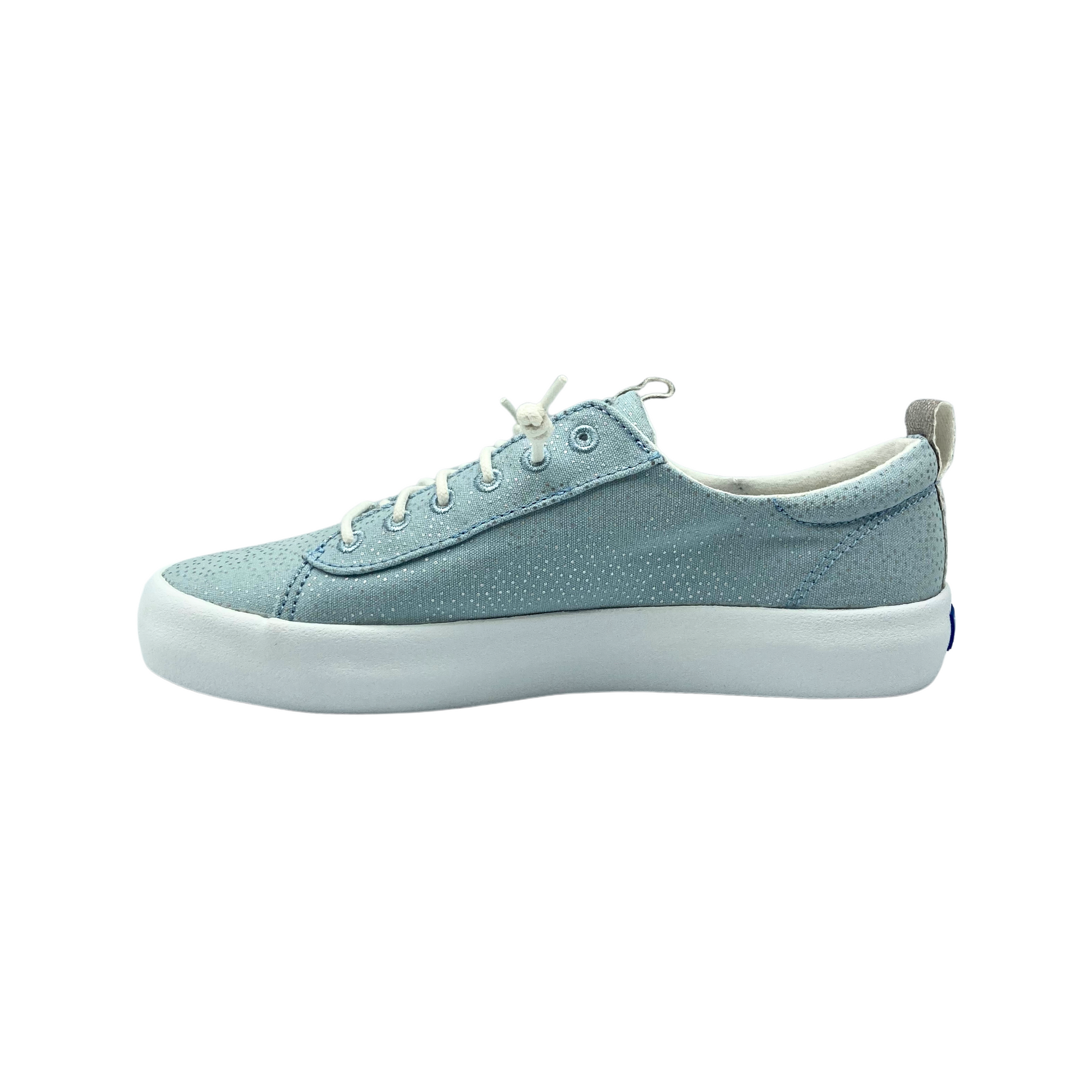 Inside view of a canvas slip on sneaker in a light blue/wilver with a white outsole.