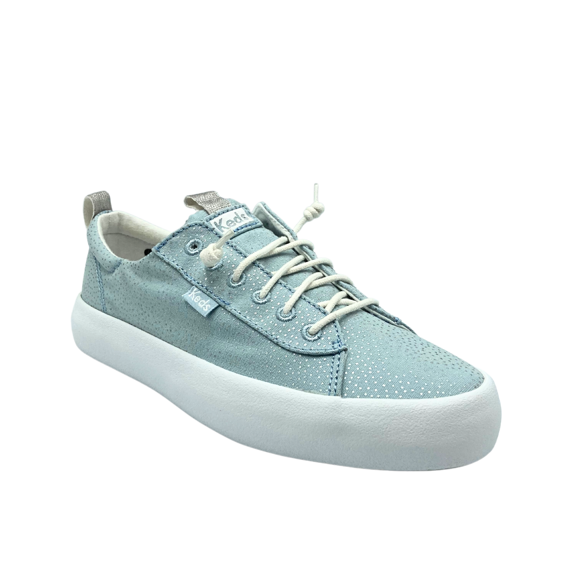 Angled front view of a canvas sneaker in a light blue/silver combo.   Elastic laces for slip on/off and white rubber outsole