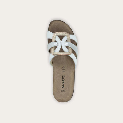 Brown sandal with white straps on a light gray background