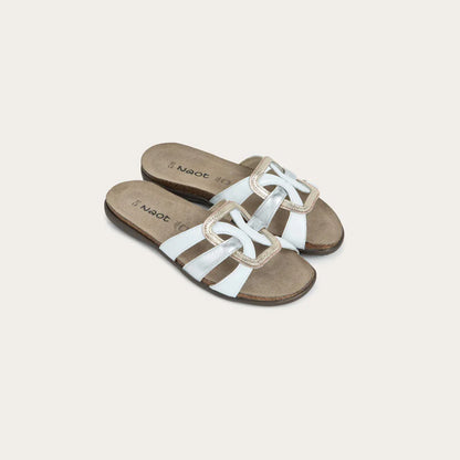 Pair of white sandals with brown soles on a light beige background