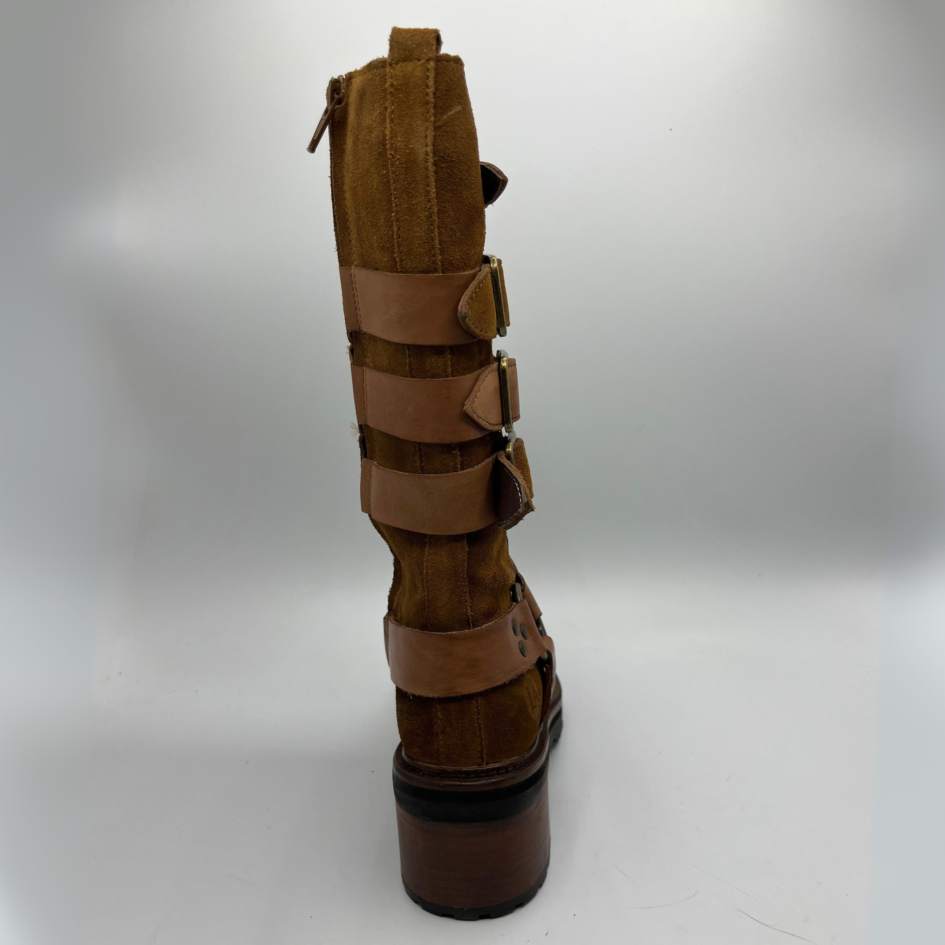 Brown leather boot with multiple straps on a white background