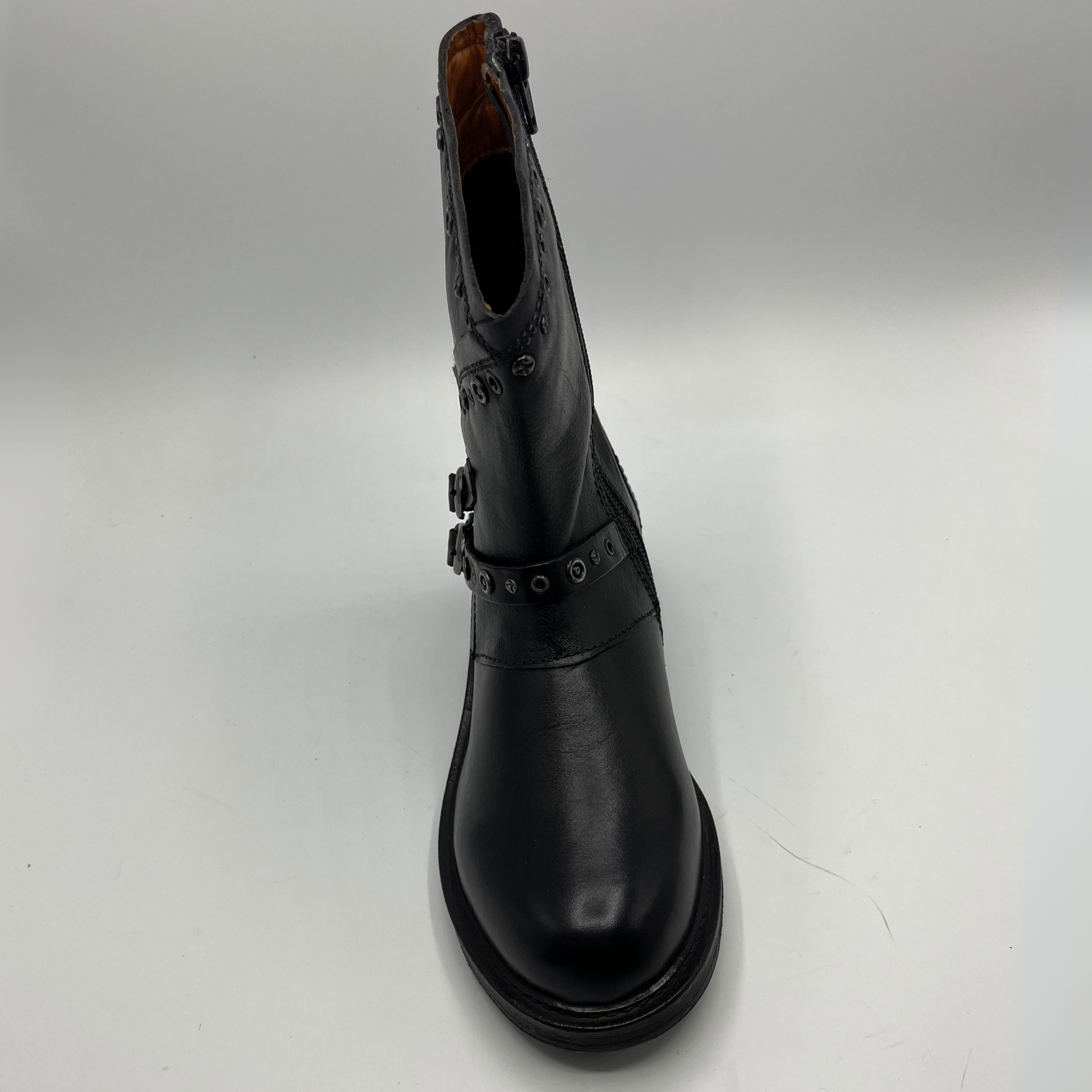 Black leather boot with buckle details on a white background
