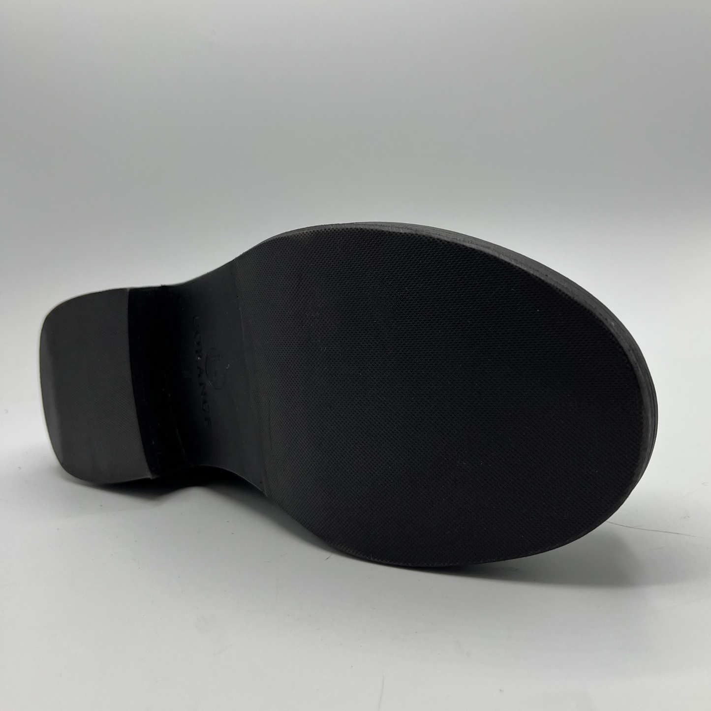 Black shoe sole on a gray background