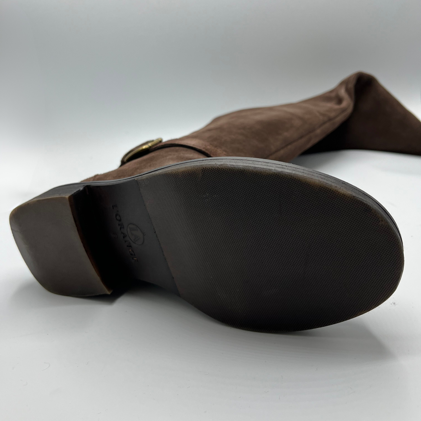 Brown suede boot with a visible brand logo on a white background