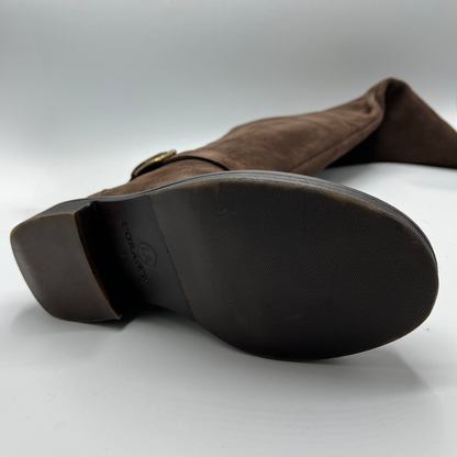 Brown suede boot with a visible brand logo on a white background