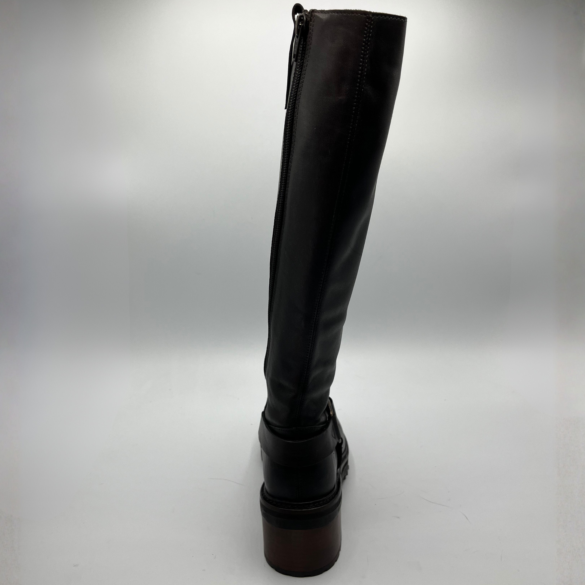 Black knee-high boot on a light gray background