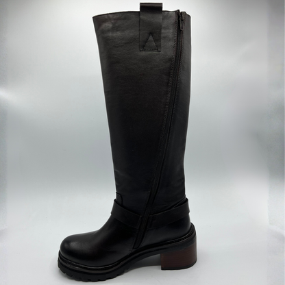 Black knee-high boot with a platform sole on a light gray background