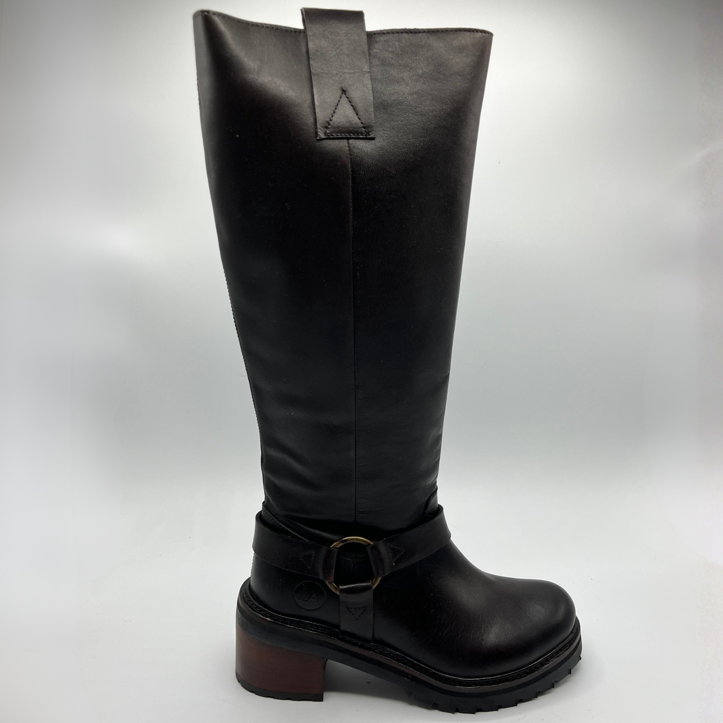 Black knee-high boot with a buckle on a white background