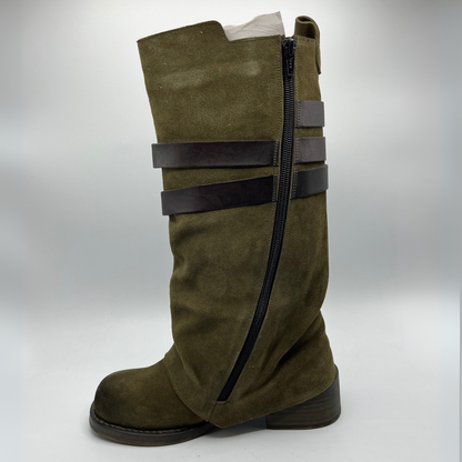 Green knee-high boot with black straps on a white background