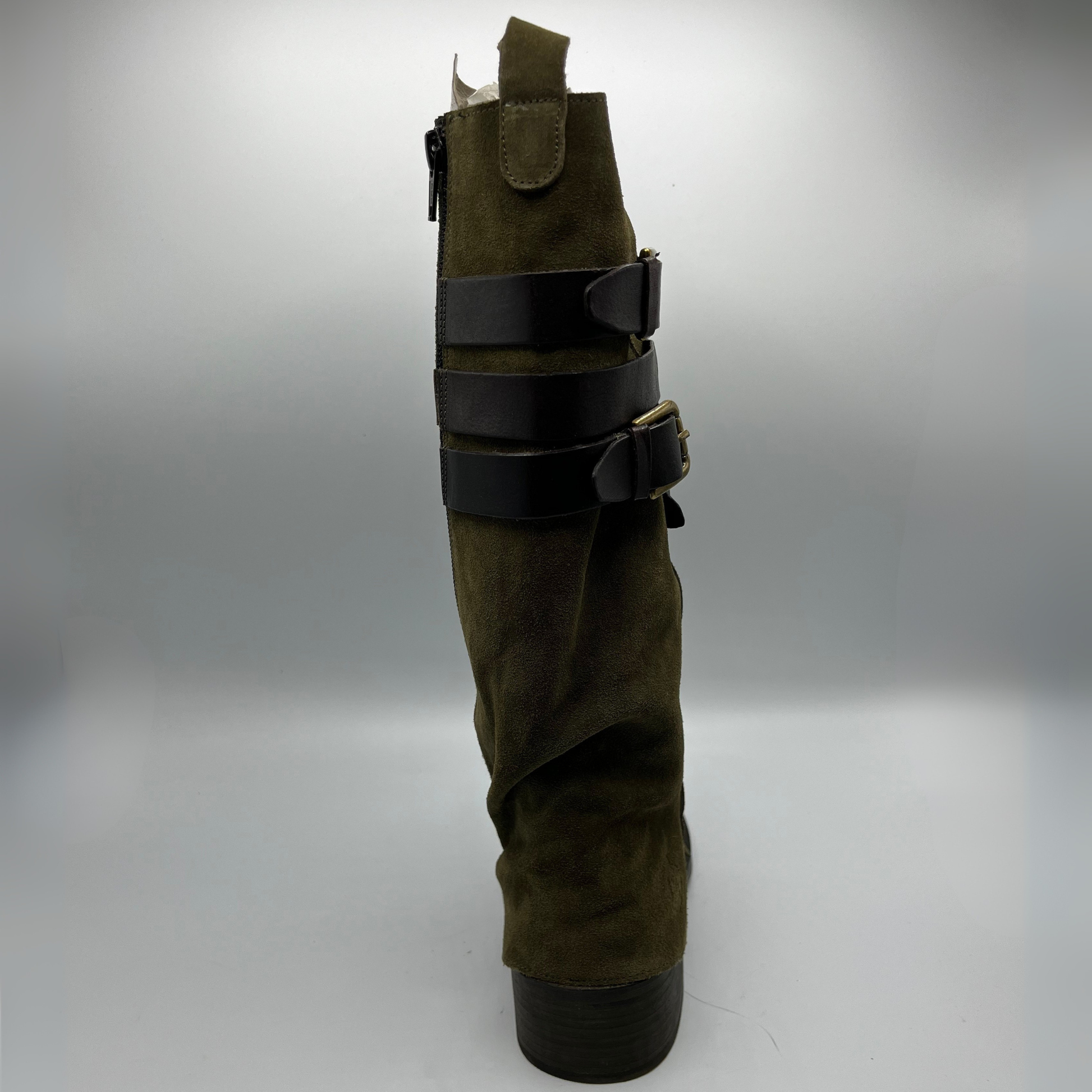 Green leather boot with black straps on a white background