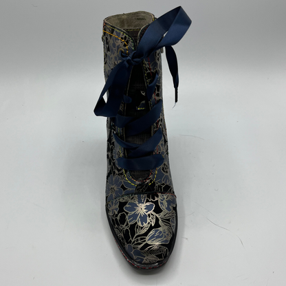 Floral-patterned boot with blue laces on a white background