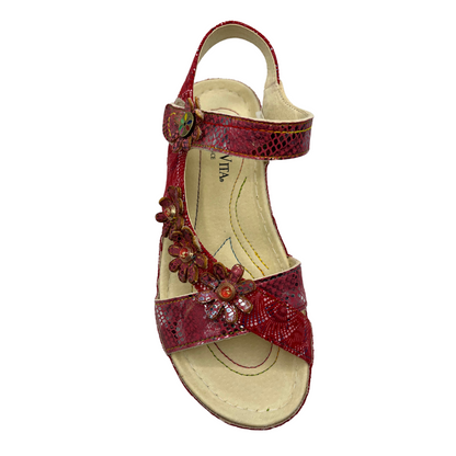 Top view of a red leather sandal with flower details and velcro ankle strap