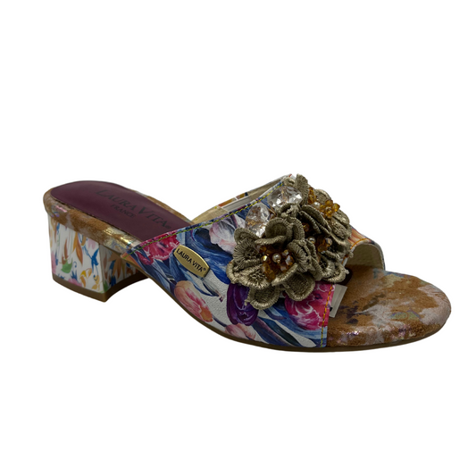 45 degree angled view of floral slip on sandal with flower accents on upper. Open toe and block heel