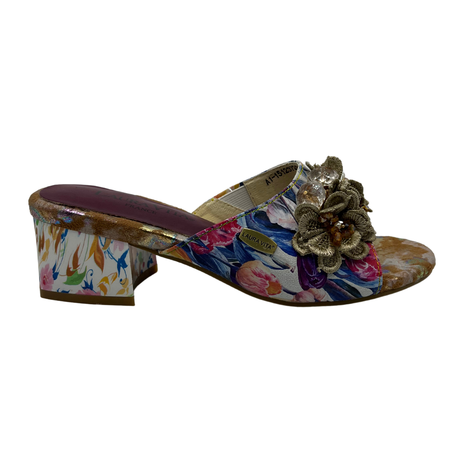 Right facing view of floral slip on sandal with flower accents on upper. Open toe and block heel