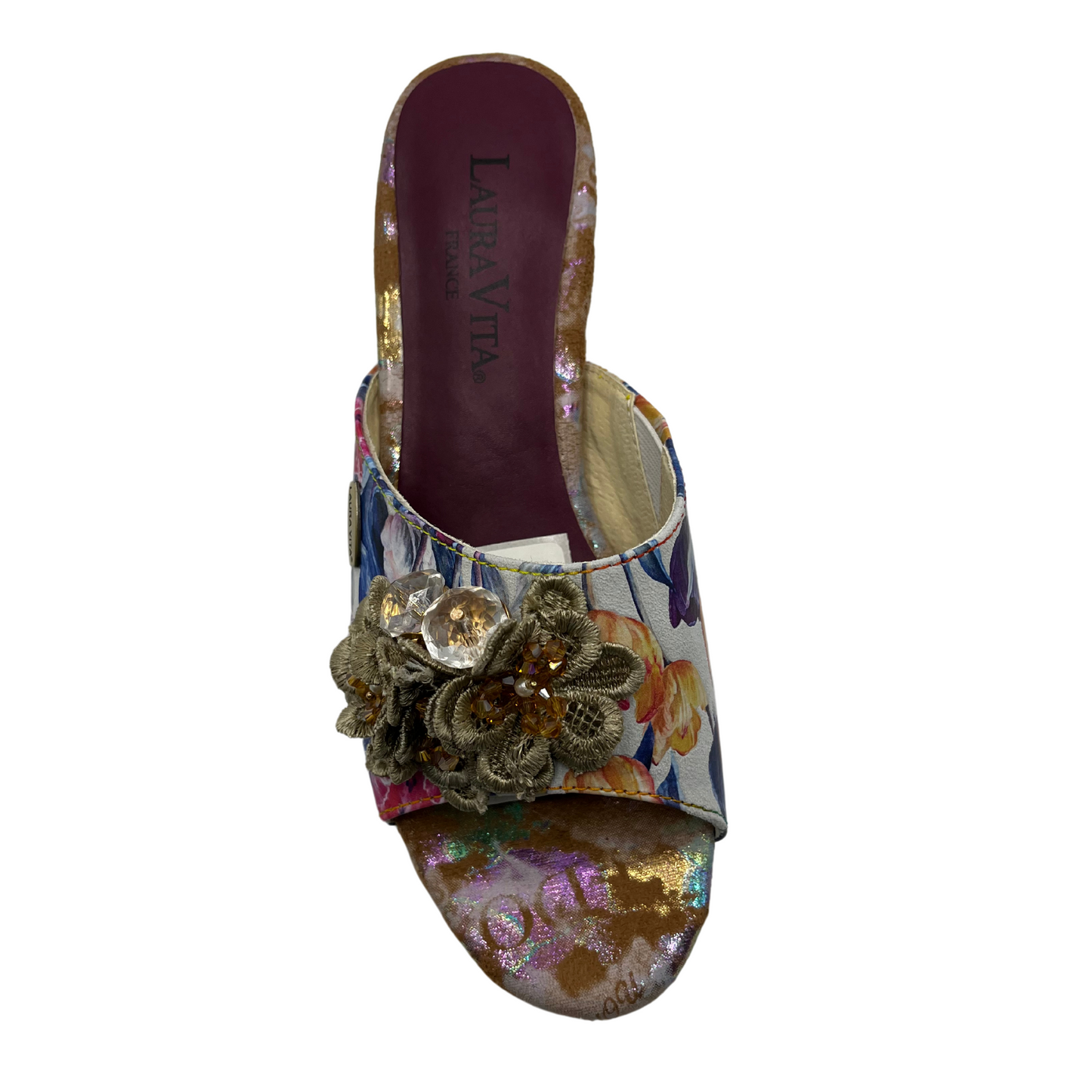 Top view of floral slip on sandal with flower accents on upper. Open toe and block heel