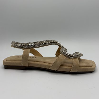Beige sandal with decorative strap on a gray background