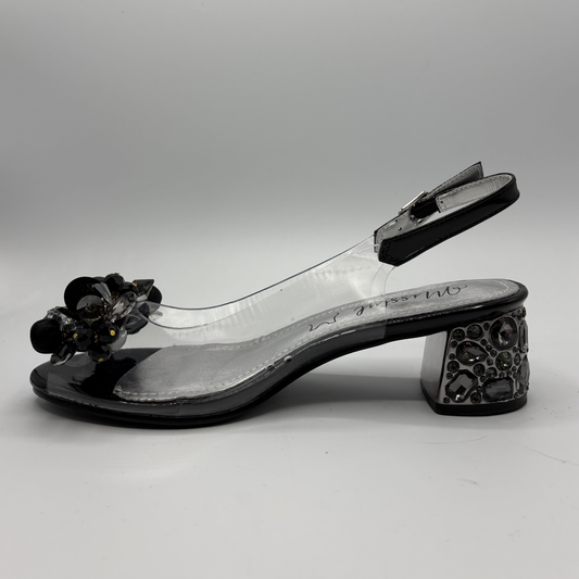 High heeled shoe with clear upper and jewelled heel on a gray background