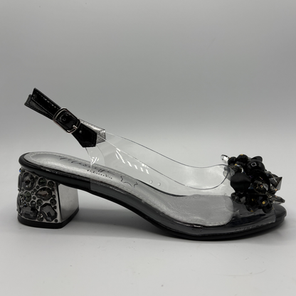 High heeled shoe with clear upper and jewelled heel on a gray background