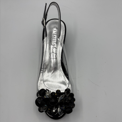 High heeled shoe with clear upper and jewelled heel on a gray background