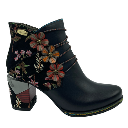 Right facing view of black leather and floral ankle boot with block heel