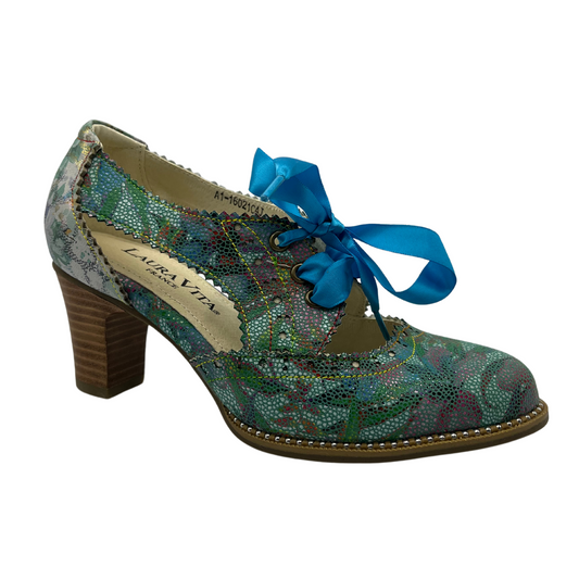 45 degree angled view of patterned leather oxford with blue ribbon laces and stacked heel.
