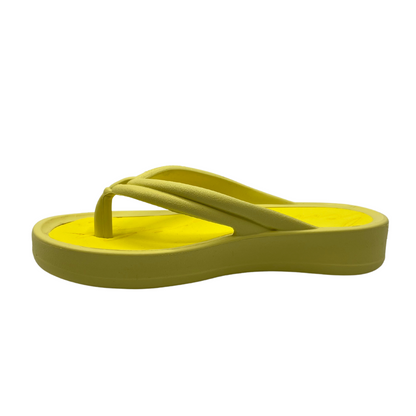 Left facing view of lemon yellow thong sandal with cushioned foam insole and platform sole