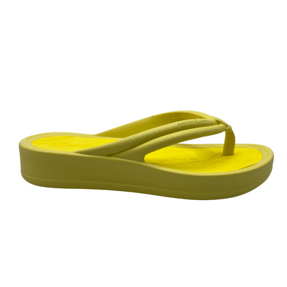 Right facing view of lemon yellow thong sandal with cushioned foam insole and platform sole