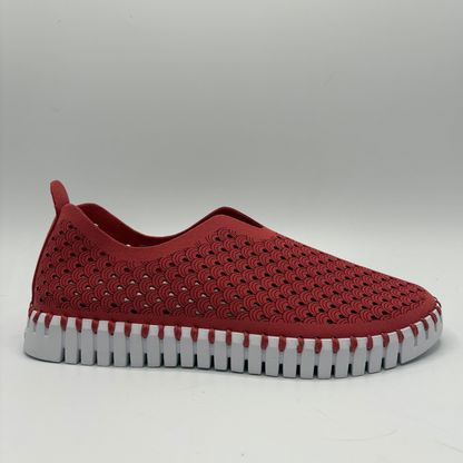 Red slip-on shoe with a textured sole on a gray background