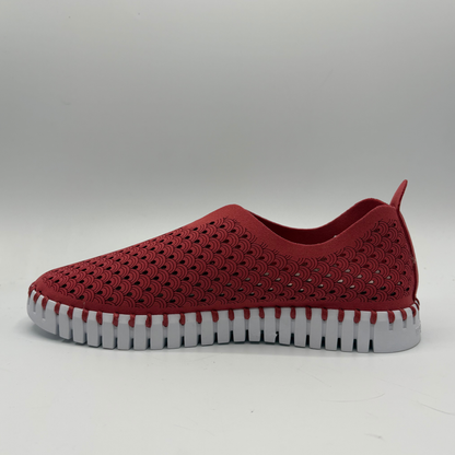 Red slip-on shoe with a white sole on a gray background