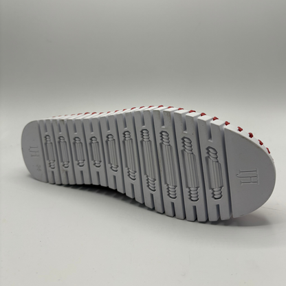 Gray shoe sole with red accents on a gray background