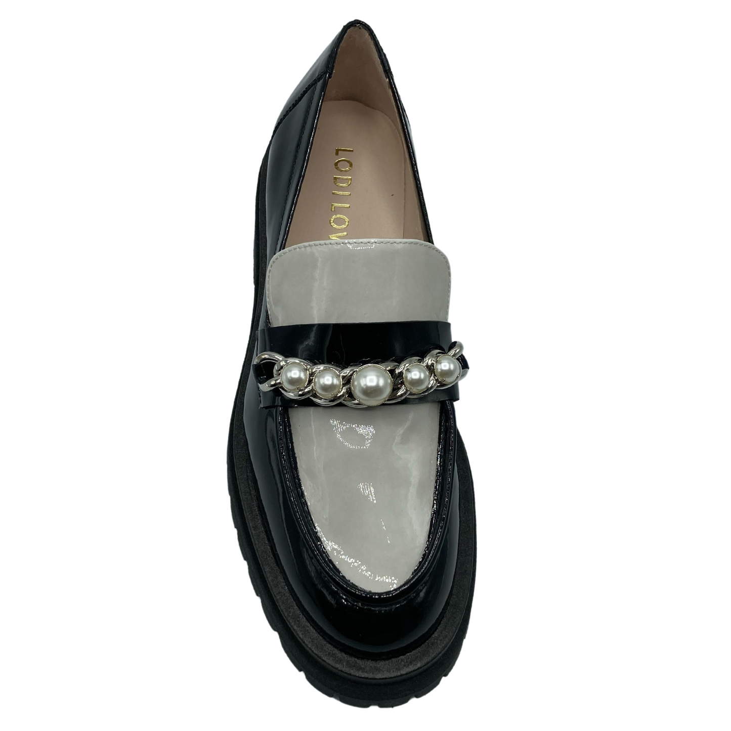 Top view of black and white patent leather loafer with pearl and chain detail on upper
