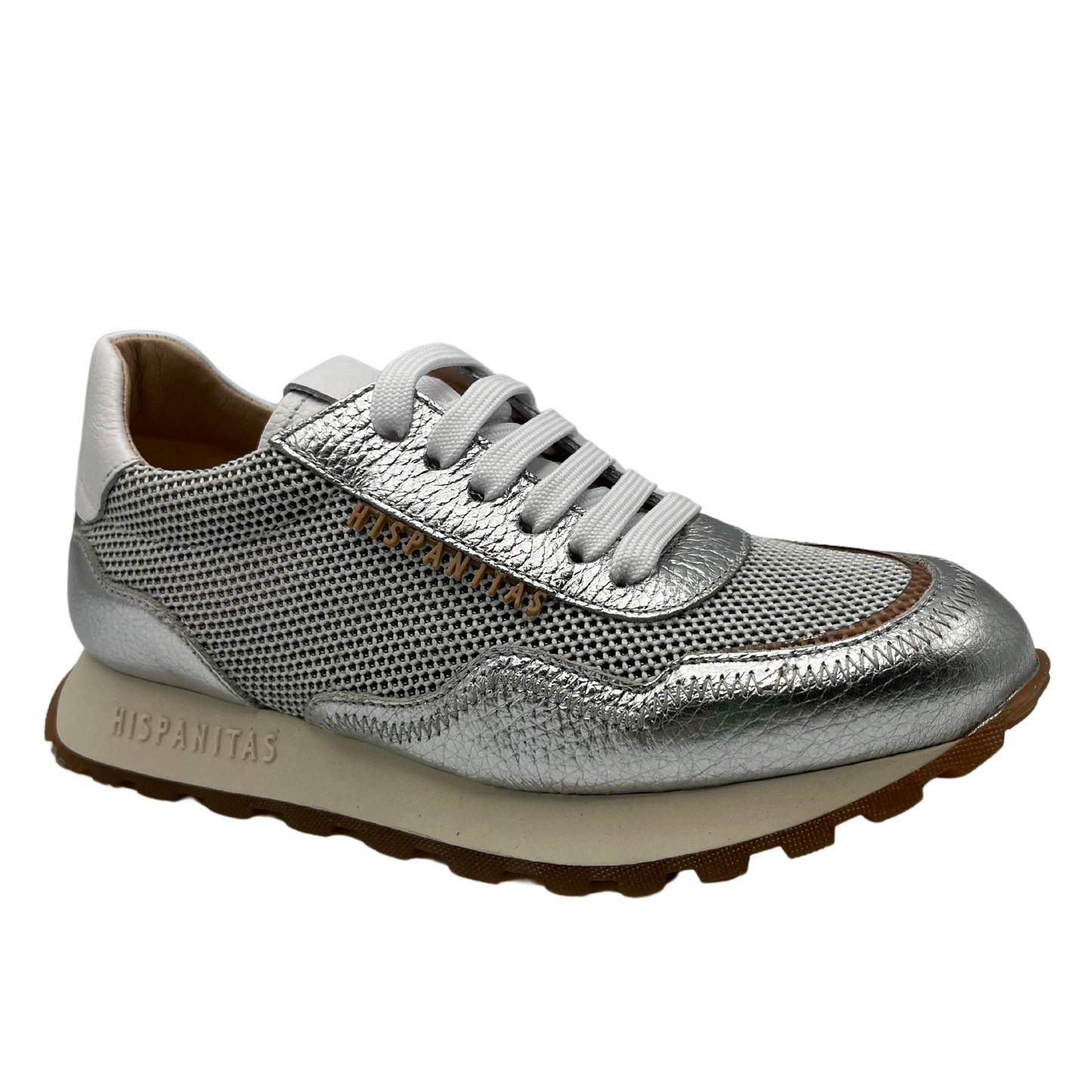 Angled view of silver and white leather sneaker with non-slip sole and leather lining.