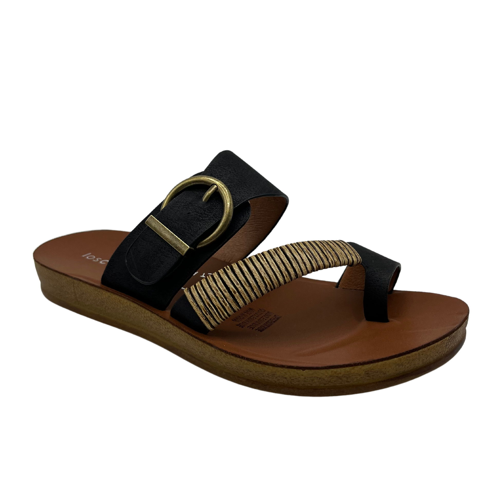 45 degree angled view of black leather sandal with gold buckle and brown insole