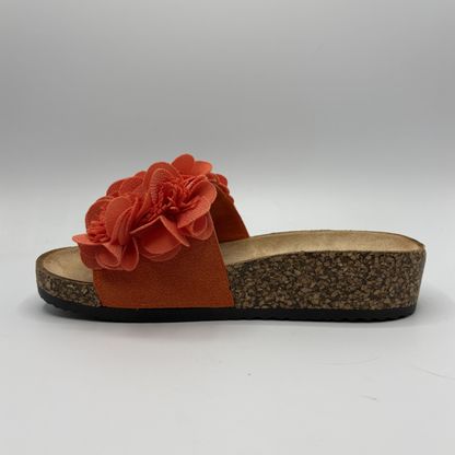 Orange sandal with a flower detail on a white background