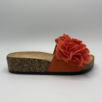 Orange sandal with a flower detail on a white background