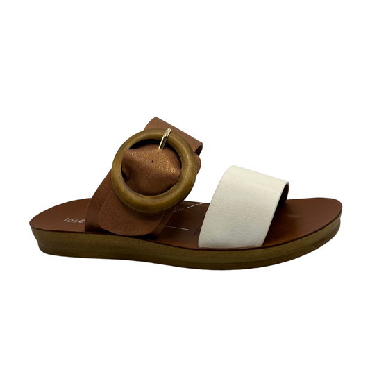 45 degree angled view of brown and white strapped sandal with lined footbed and oversized buckle detail