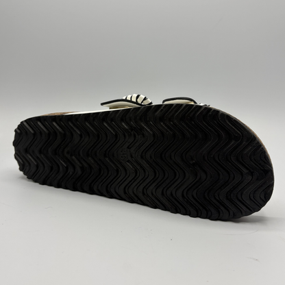 Black rubber sole of a shoe on a gray background