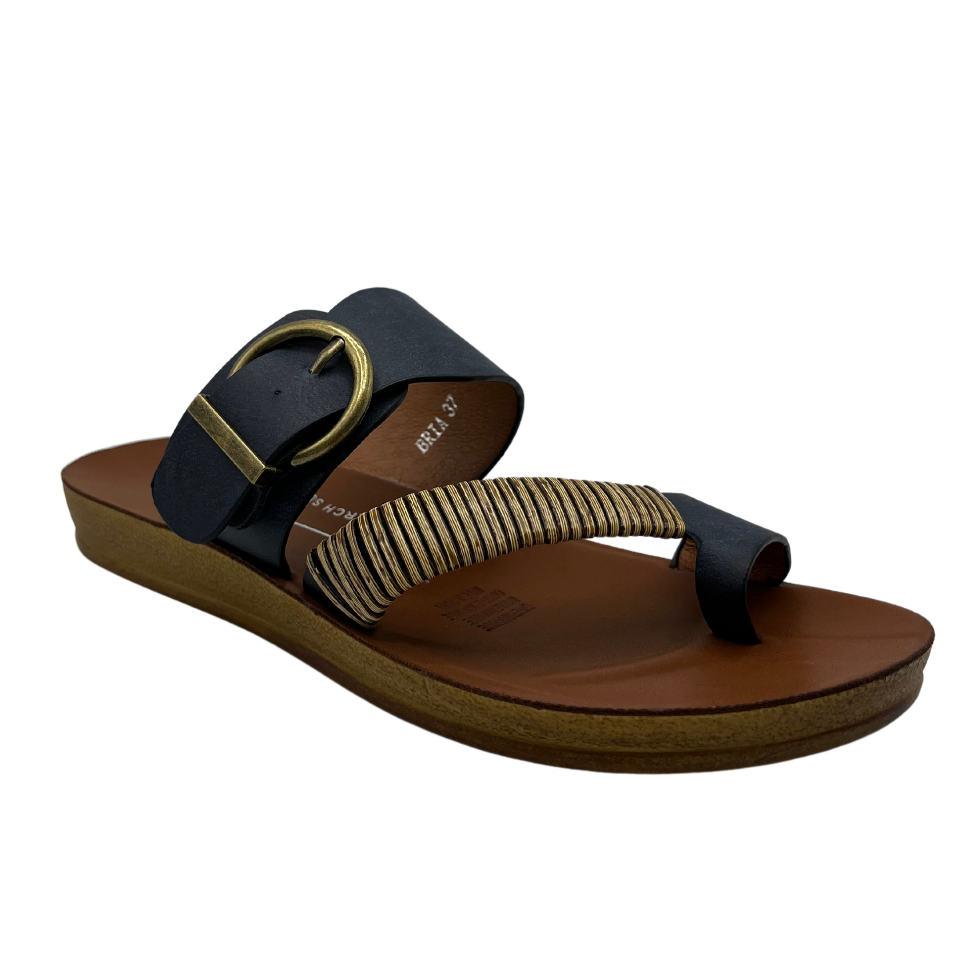 45 degree angled view of navy leather sandal with gold buckle and brown insole