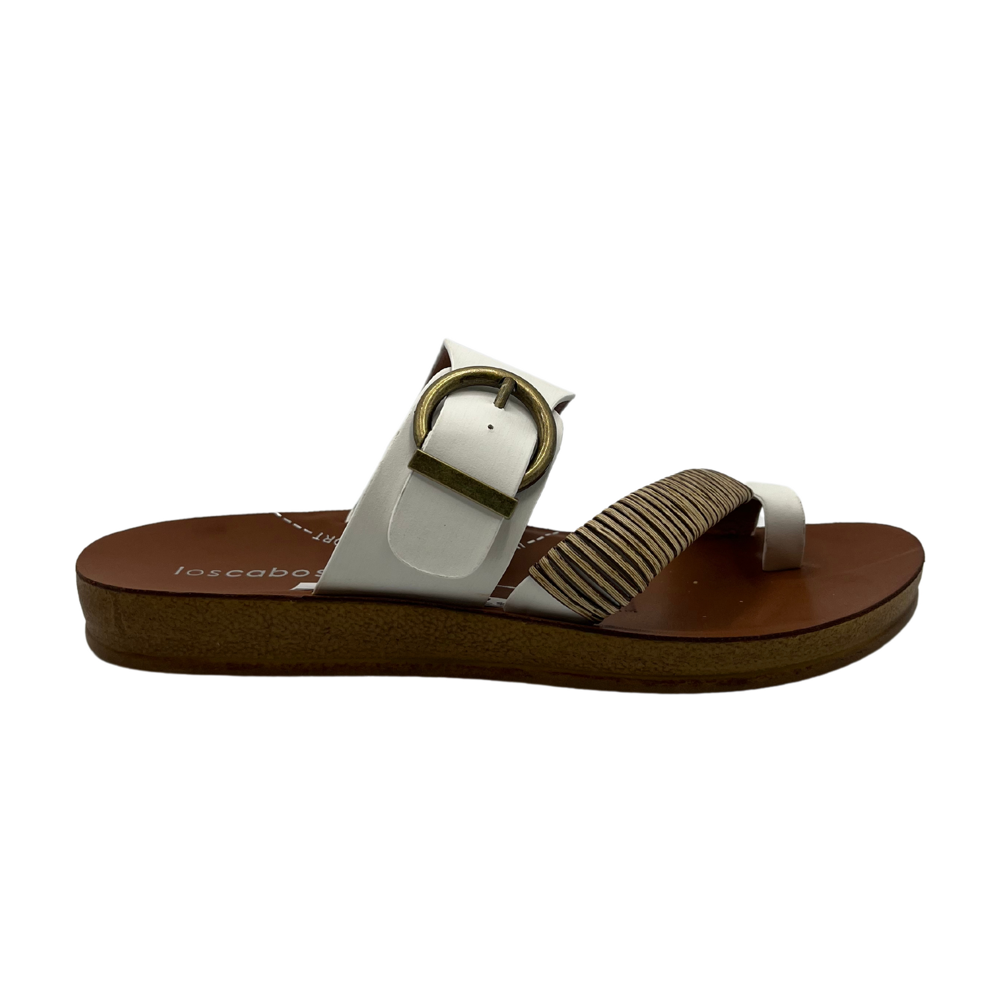 Right facing view of white leather sandal with gold buckle and brown insole