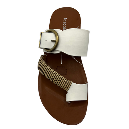 Top view of white leather sandal with gold buckle and brown insole