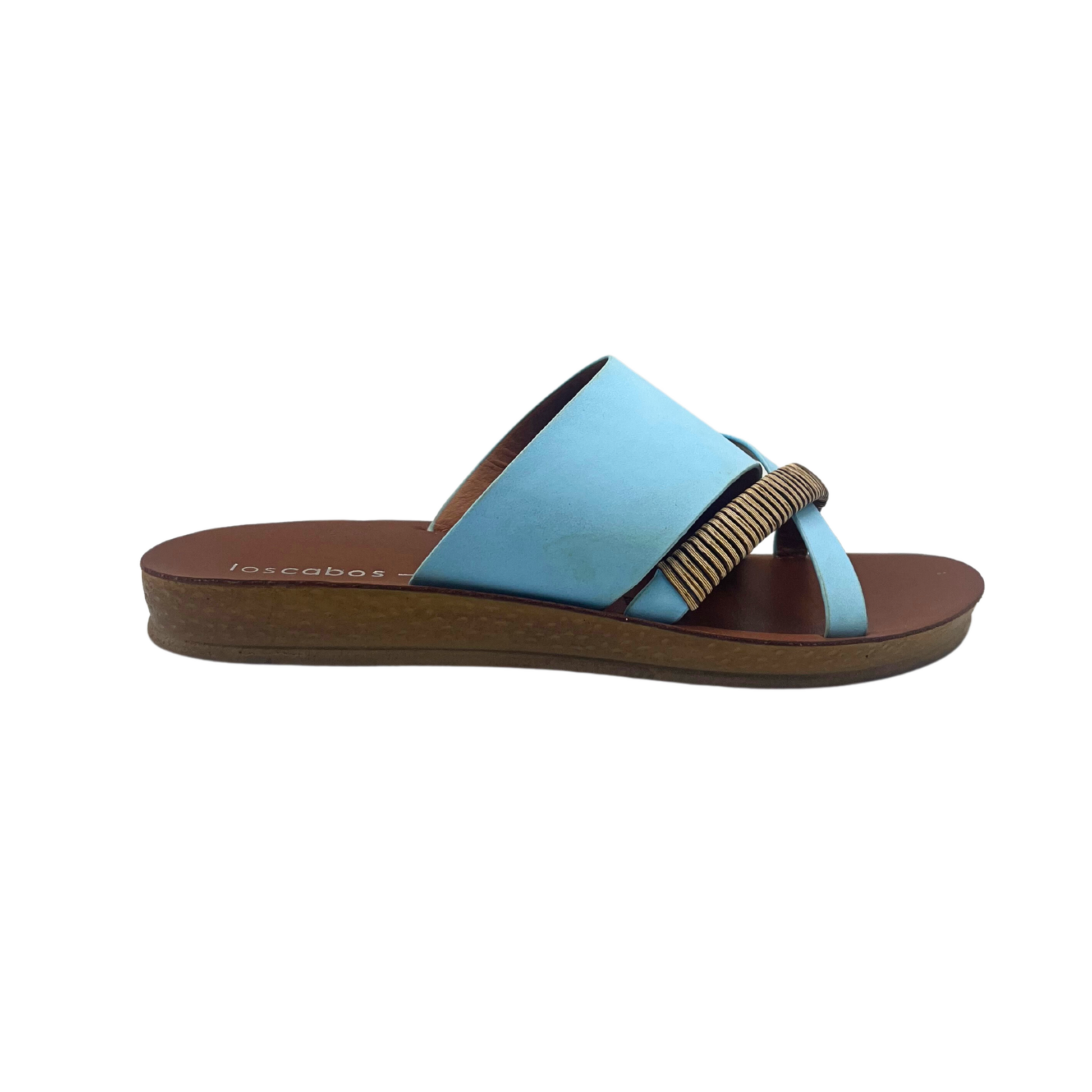 Outside view of a slip on sandal.  Open toe and heel.  Chalk blue leather