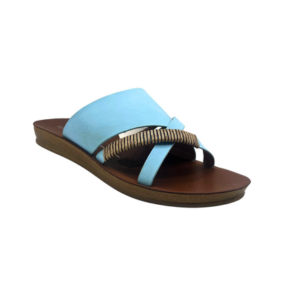 Angled side view of a slip on sandal in a chalk blue leather.