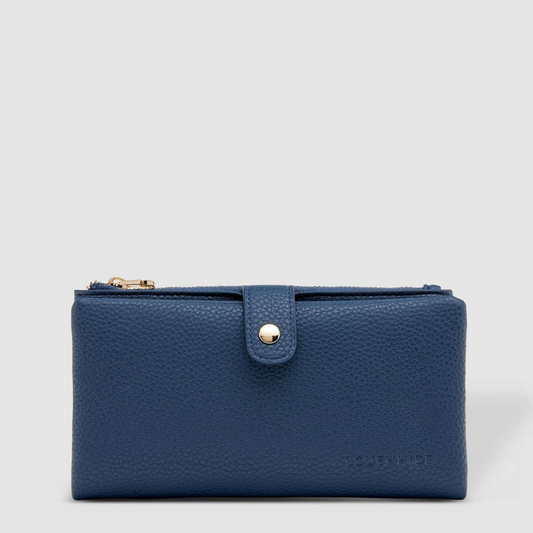 Blue Louenhide Stella wallet with textured finish and front button clasp, isolated on a light grey background.