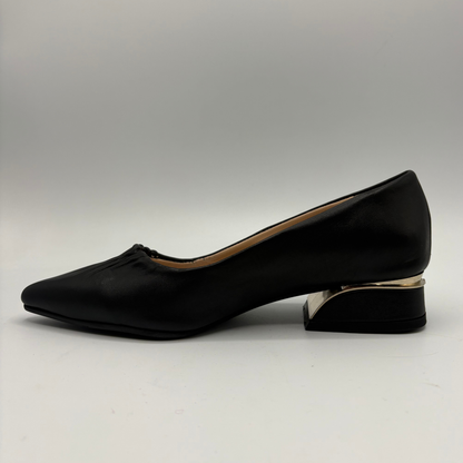 Left facing view of a black leather pump with a slouchy accent on the pointed toe and a gold accent on the heel