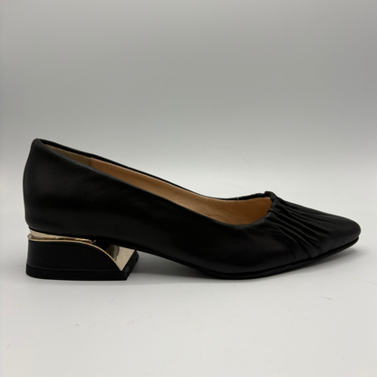 Right facing view of a black leather pump with a slouchy accent on the pointed toe and a gold accent on the heel