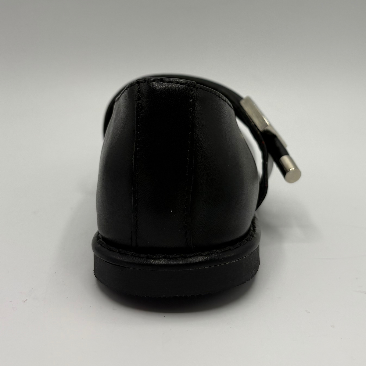 Back view of a black leather ballet flat shoe with silver accents